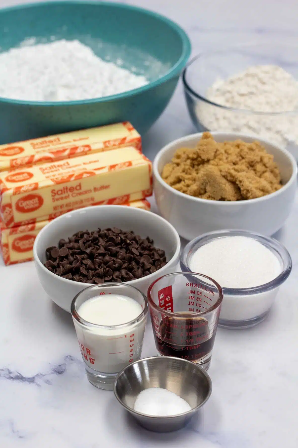 Tall image showing chocolate chip cookie dough ingredients.