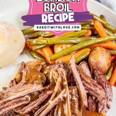 Crockpot London broil Pinterest pin showing a plate of tender, shredded London broil in gravy with cooked potatoes, carrots, and green beans.