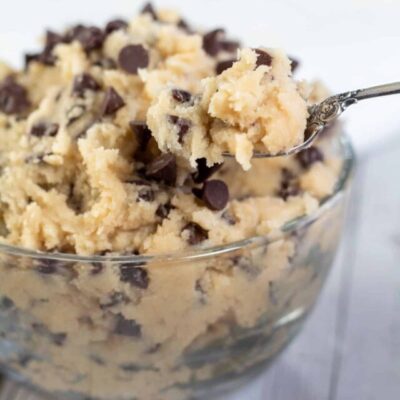 Tall image showing a glass bowl of edible chocolate chip cookie dough.
