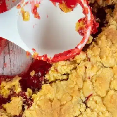 Wide image showing strawberry dump cake in a 9x13 glass baking dish.