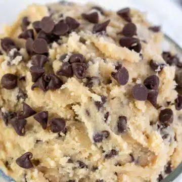 Wide image showing a glass bowl of edible chocolate chip cookie dough.