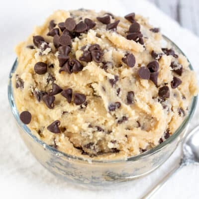Square image showing a glass bowl of edible chocolate chip cookie dough.