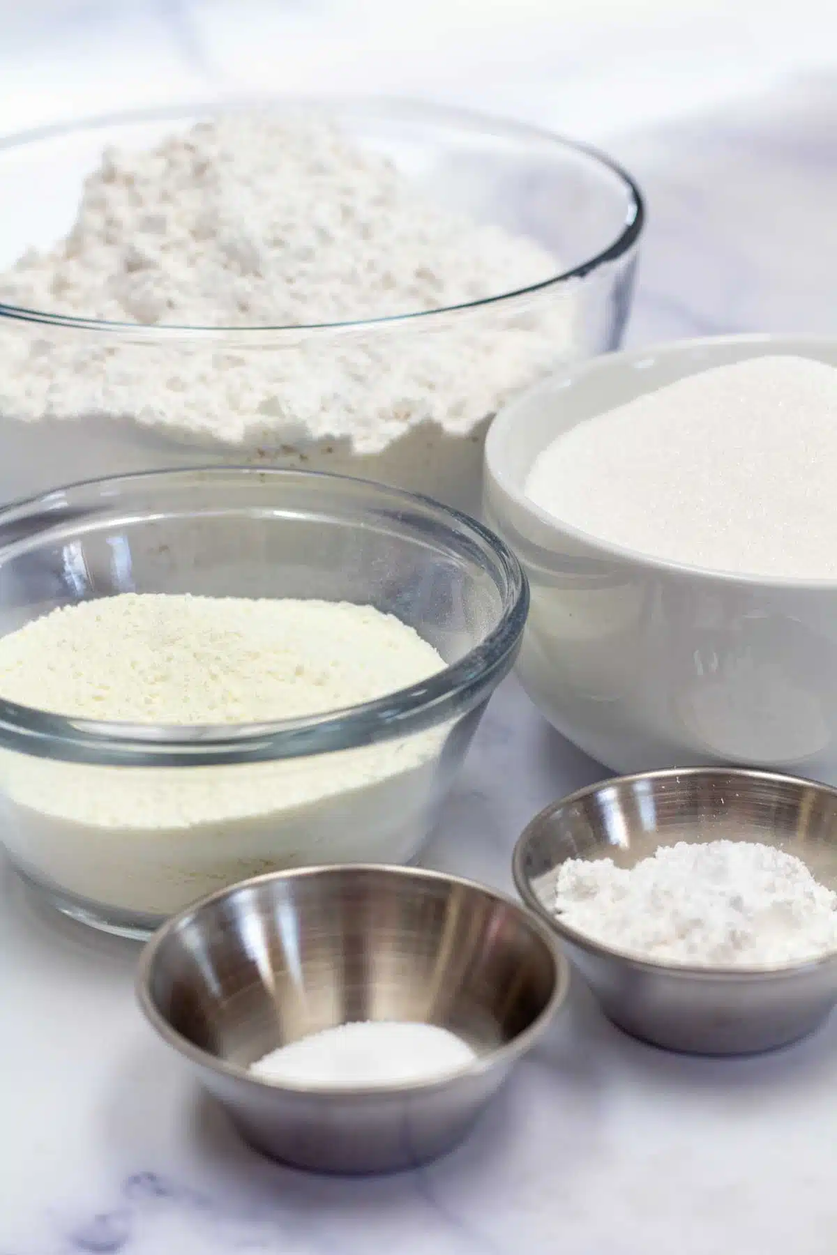Tall image showing the dry ingredients needed for white cake mix.