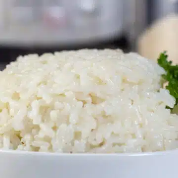 Wide image of long grain white rice cooked in a instant pot.