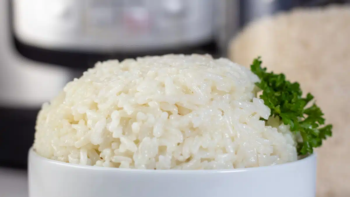 Wide image of long grain white rice cooked in a instant pot.