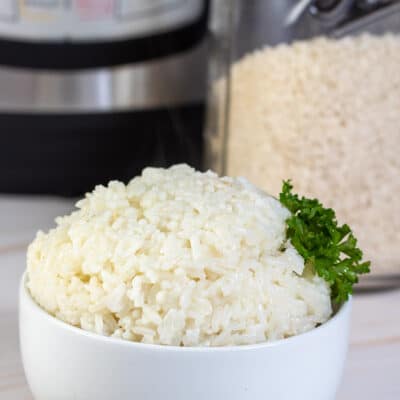 Square image of long grain white rice cooked in a instant pot.