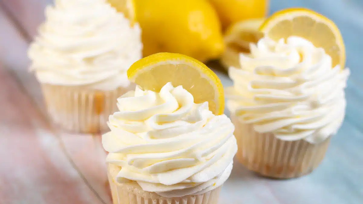 Wide image of a cup cake with lemon cream cheese frosting.