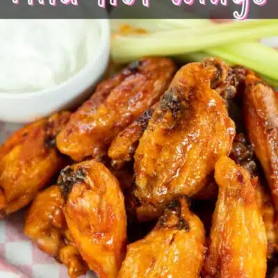 Pin image with text showing mild buffalo sauce on chicken wings.