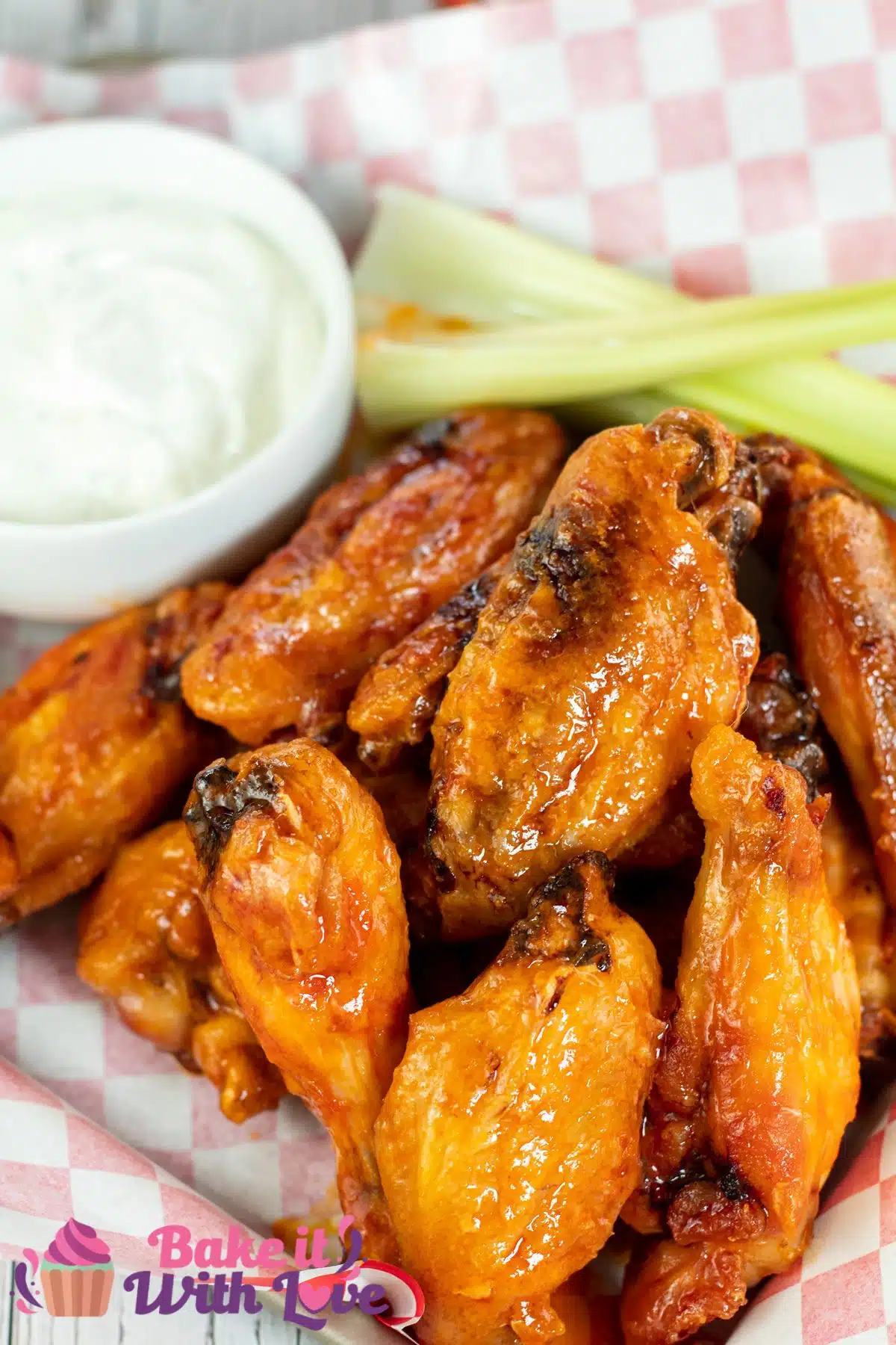 Tall image showing mild buffalo sauce on chicken wings.