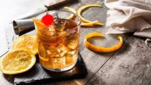 Wide image showing old fashioned cocktail drink.
