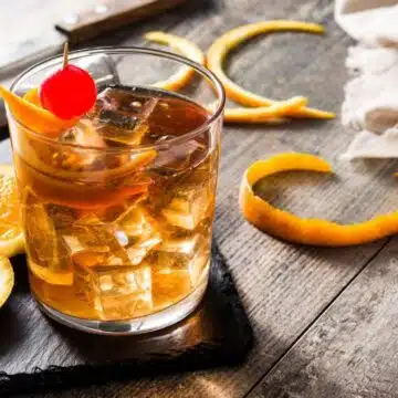 Wide image showing old fashioned cocktail drink.