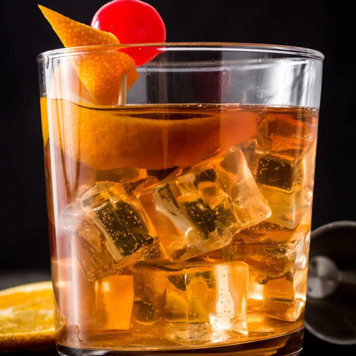 Square image showing old fashioned cocktail drink.