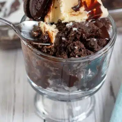 Pin image with text of Oreo dump cake in a glass dish with ice cream.