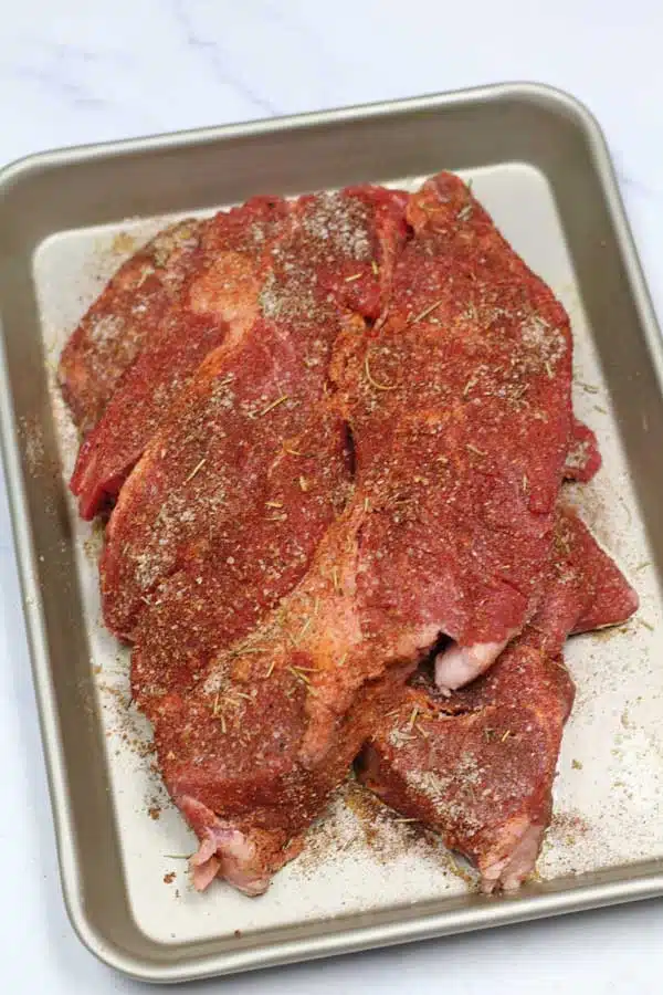 Process image 3 showing chuck steak with seasoning rubbed over.