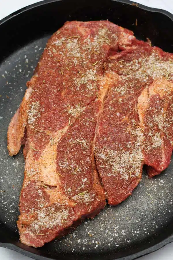 Process image 4 showing chuck steak in cast iron pan.