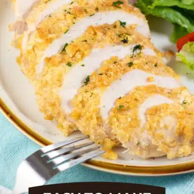 Pin image with text showing sliced Ritz chicken on a plate with a green salad.