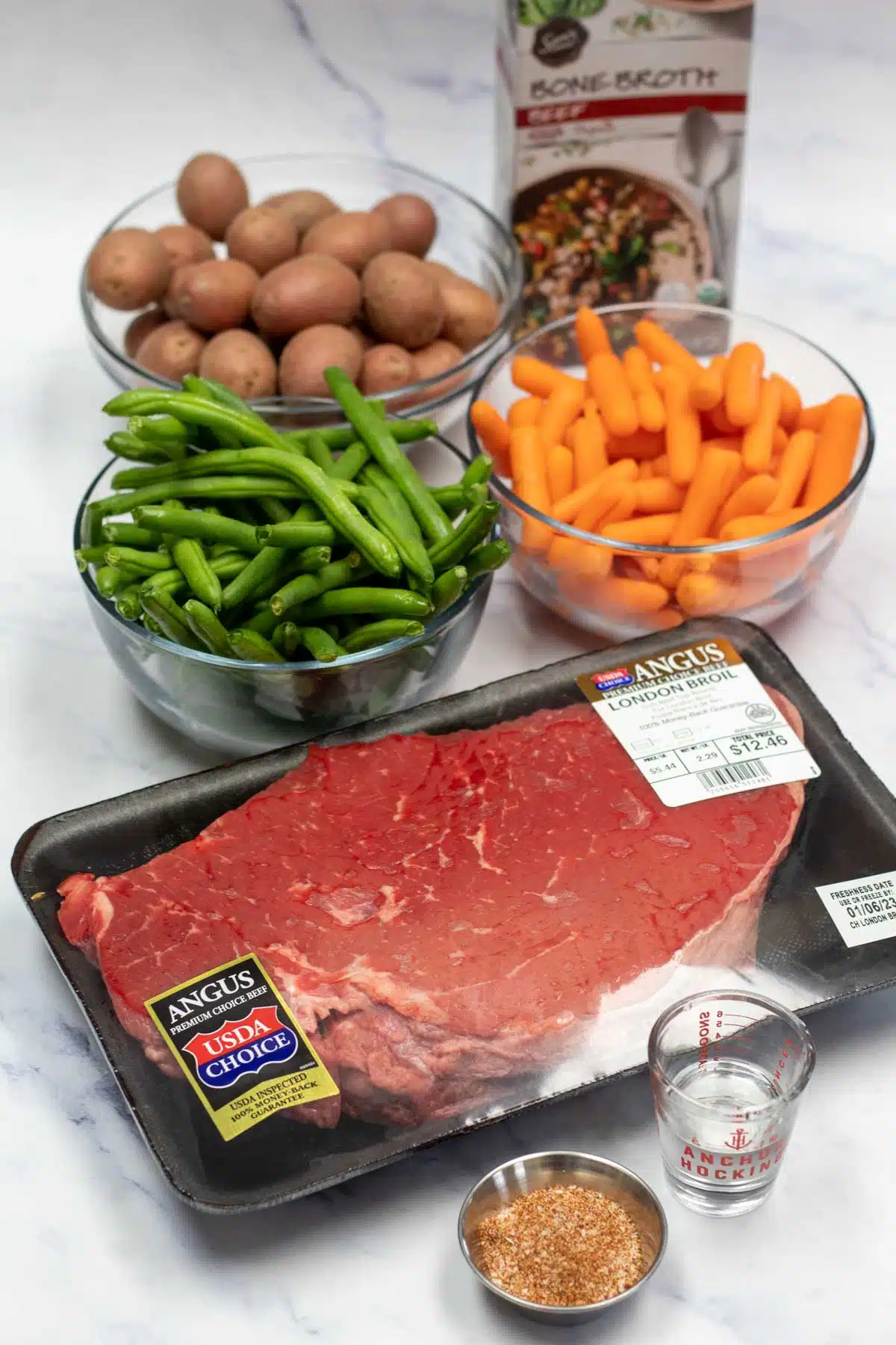 Tall image showing slow cooker London broil ingredients.