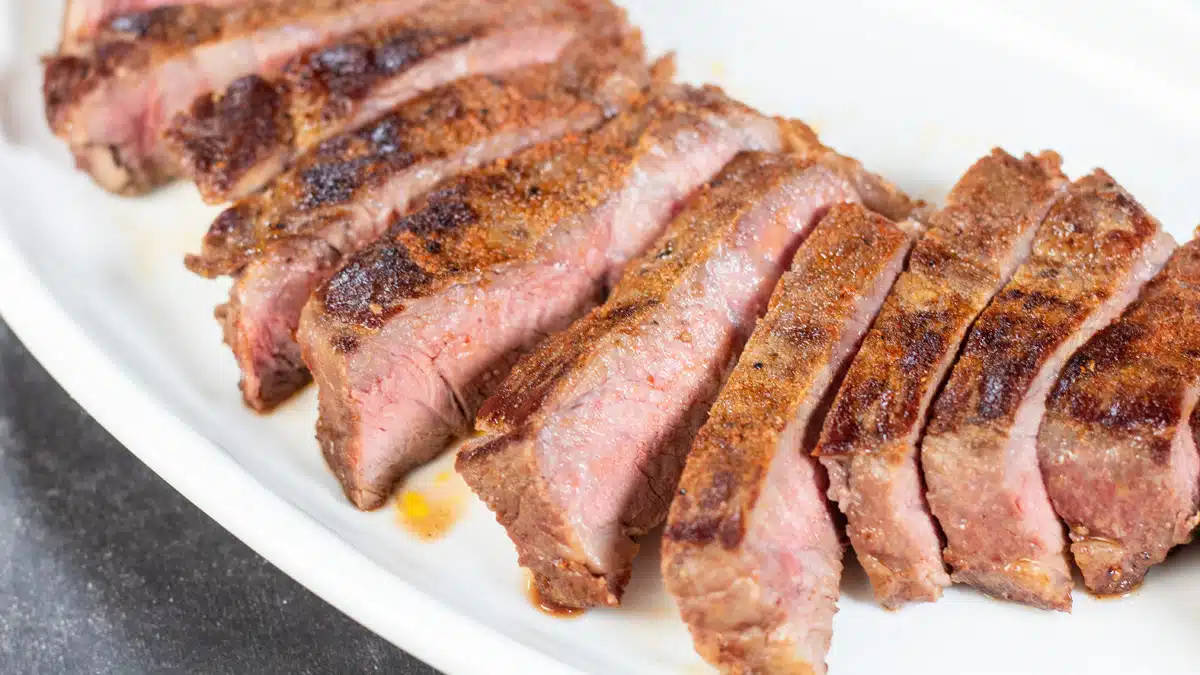 Wide image of sliced sous vide New York steak.