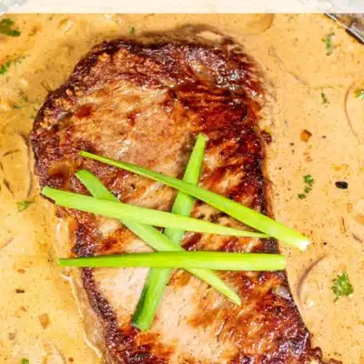 Pin image with text of steak diane in a pan.