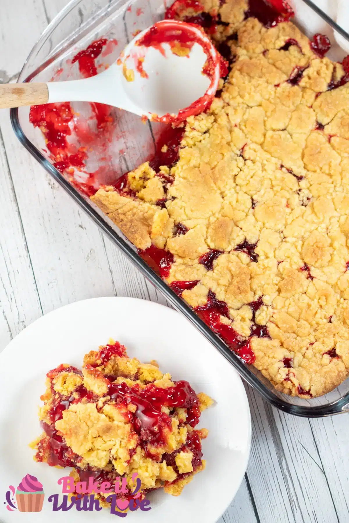 Tall image showing strawberry dump cake in a 9x13 glass baking dish.