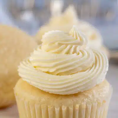 Square image showing vanilla buttercream frosting on a cupcake.