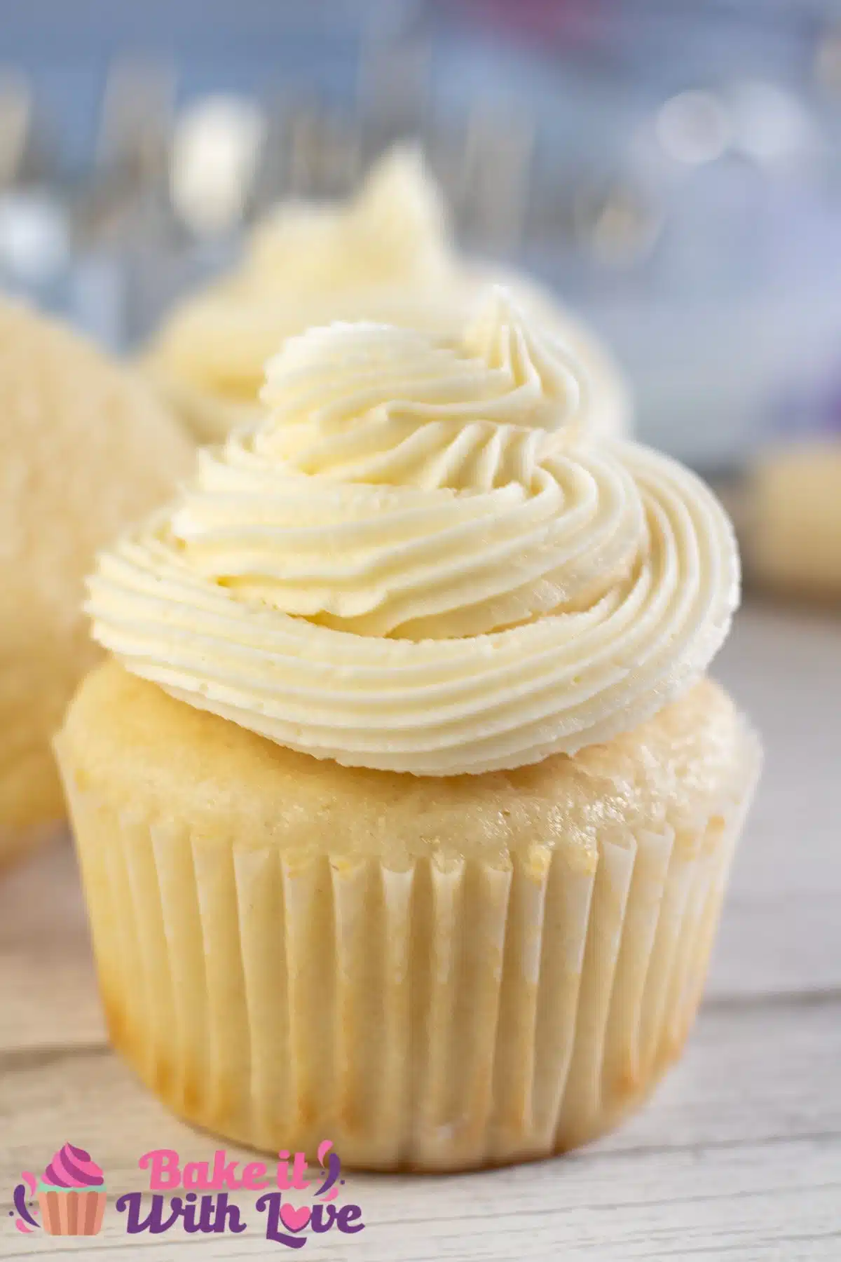 Tall image showing vanilla buttercream frosting on a cupcake.