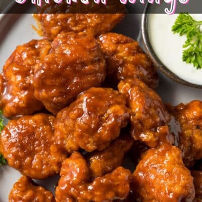 Pin image with text of boneless chicken wings on a plate.