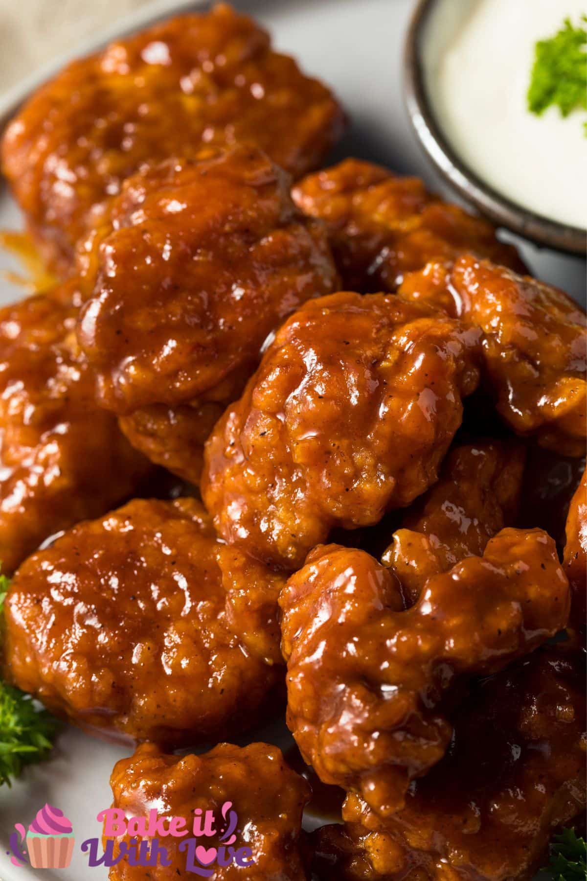 Tall image of boneless chicken wings on a plate.