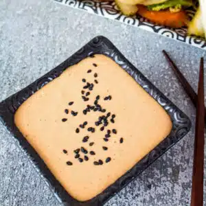 Square image of yum yum sauce in a small black dish.