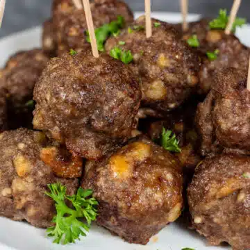 Wide image showing air fryer meatballs on a white plate.