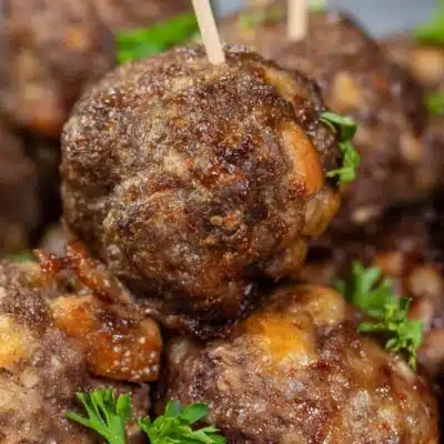 Pin image with text showing air fryer meatballs on a white plate.