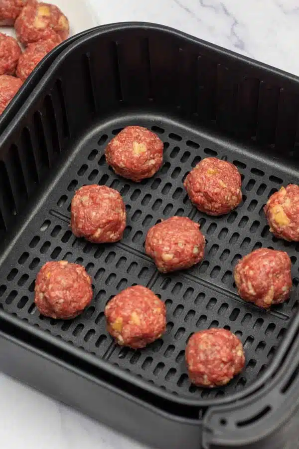 Process image 4 showing meatballs in air fryer basket.