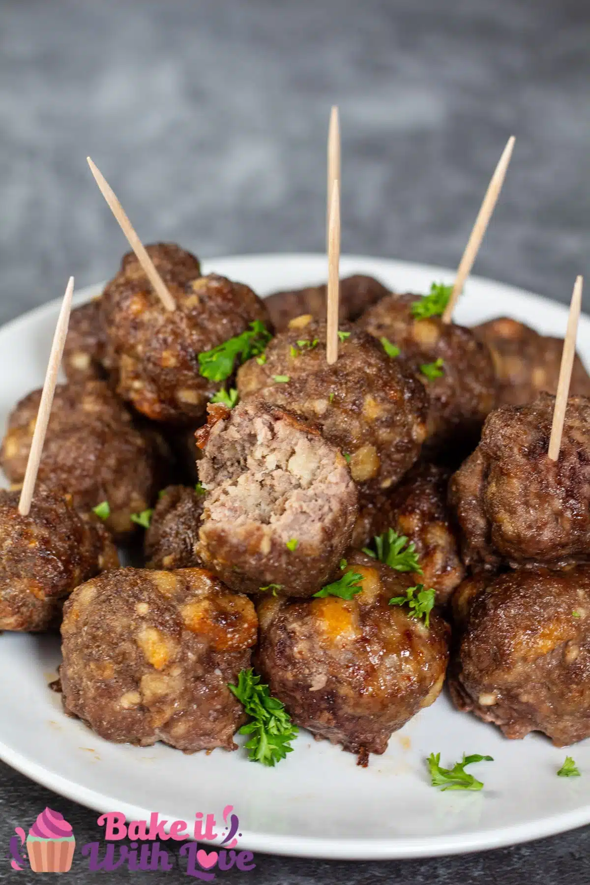 Tall image showing air fryer meatballs on a white plate.