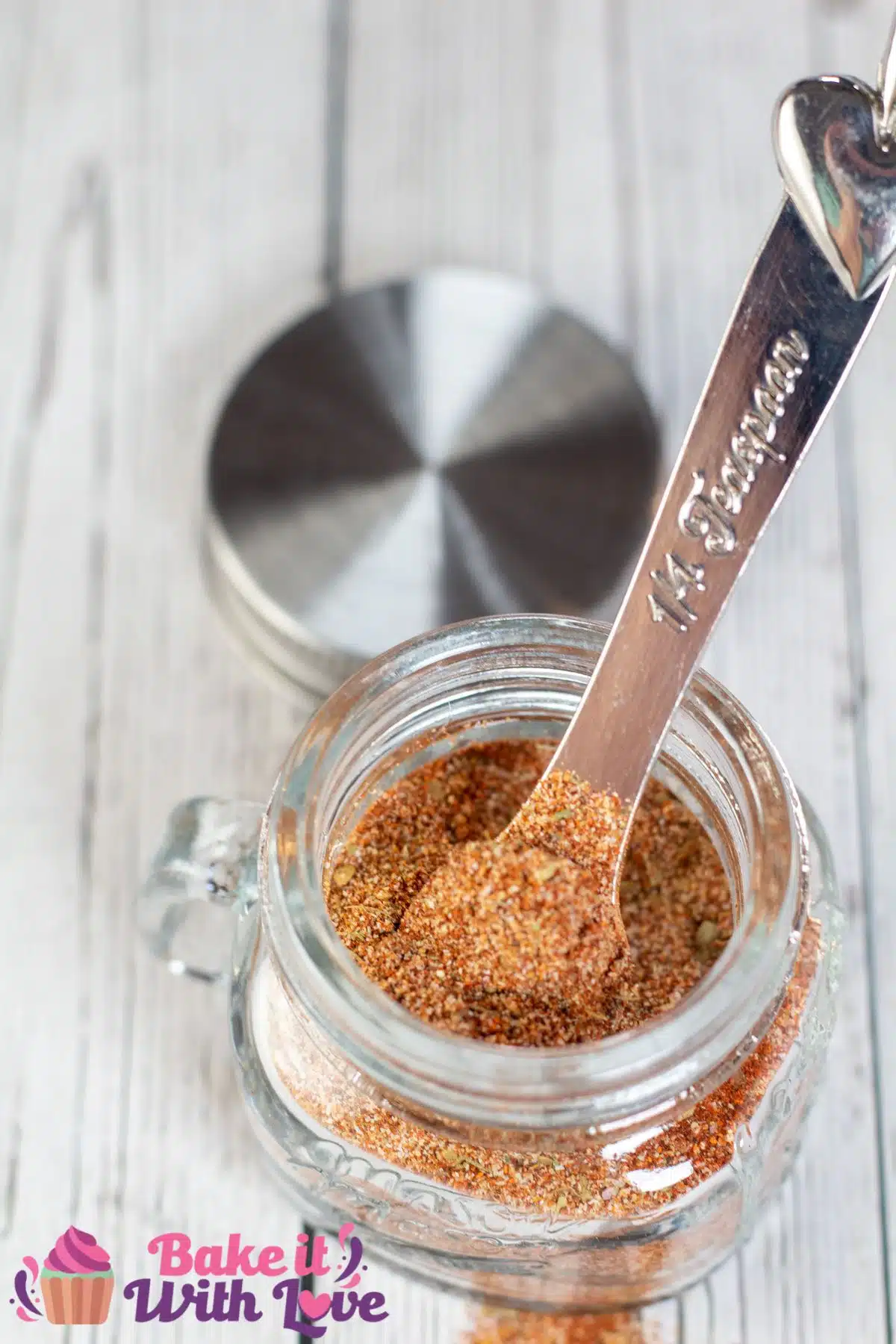 Tall image of a glass jar filled with homemade all purpose seasoning.
