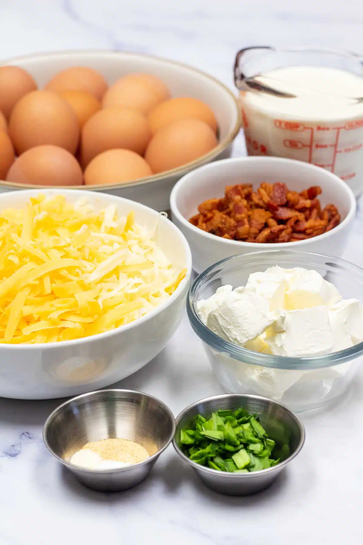 Tall image showing bacon breakfast casserole ingredients.