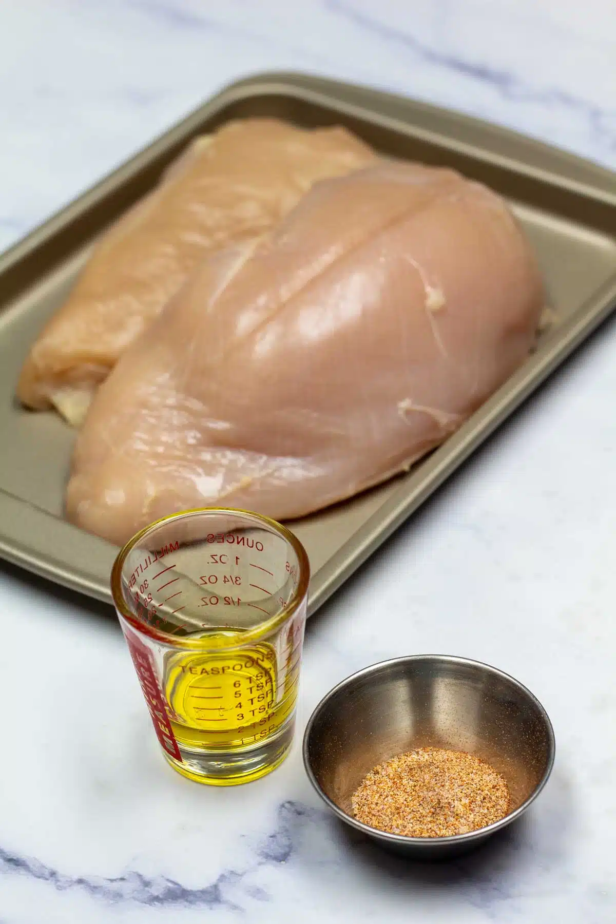 Ingredients needed for baked boneless chicken breasts.
