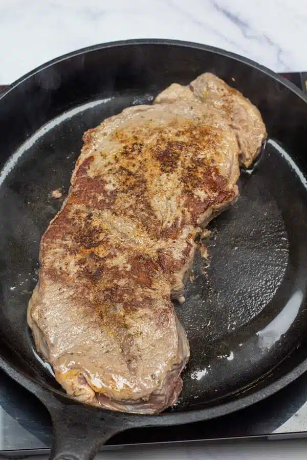 Process image 3 showing searing the other side of chuck steak before baking.