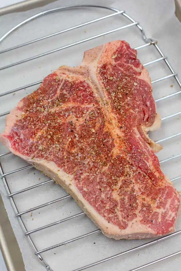 Process image 1 showing seasoned t bone steak.