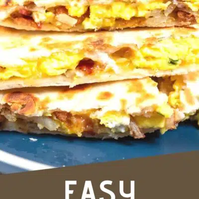 pin image with text of breakfast quesadillas on a dark blue plate.