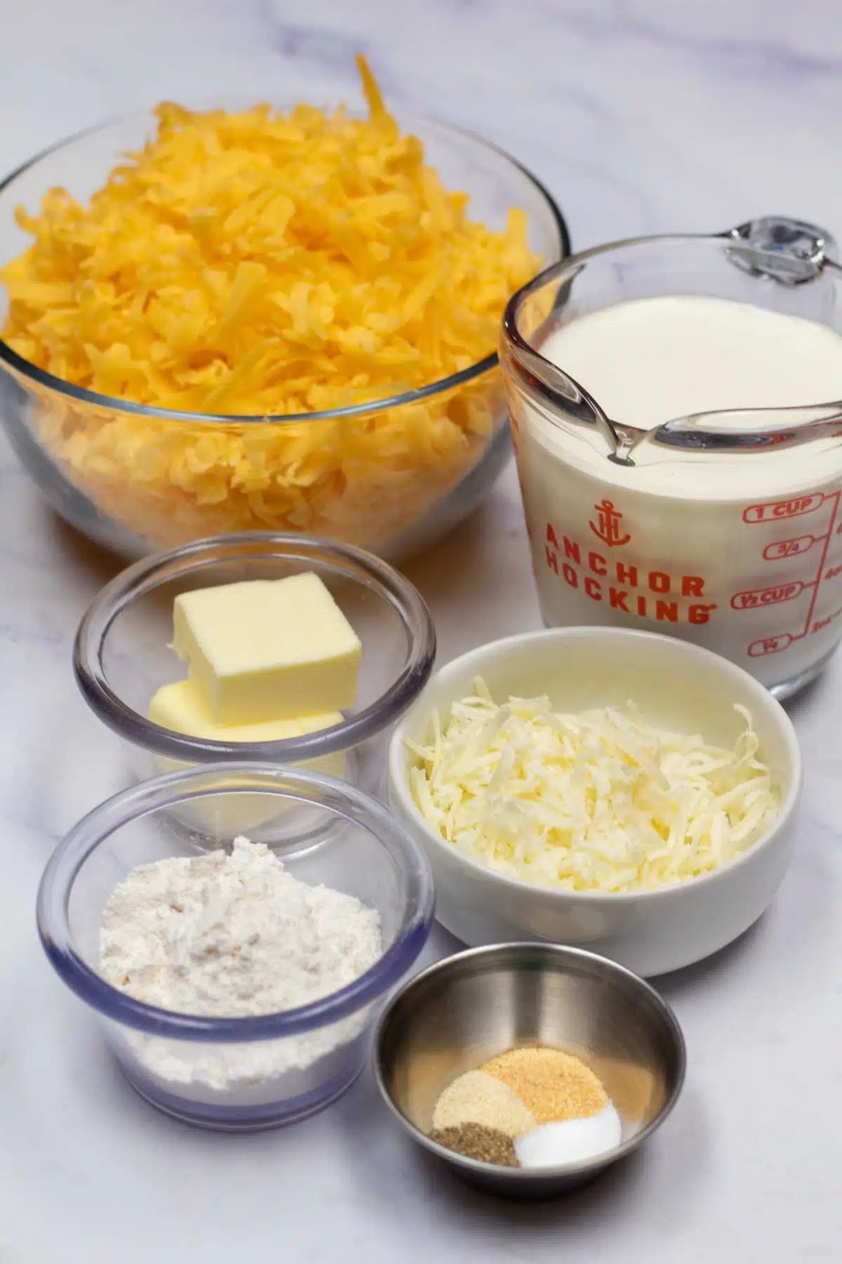 Tall image showing ingredients needed for cheese sauce.