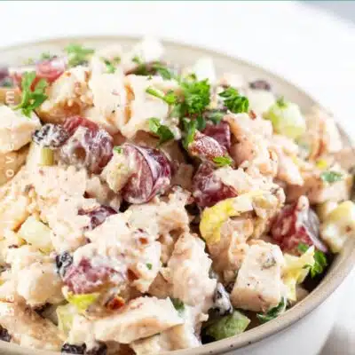 Pin image of a bowl of chicken salad with grapes.