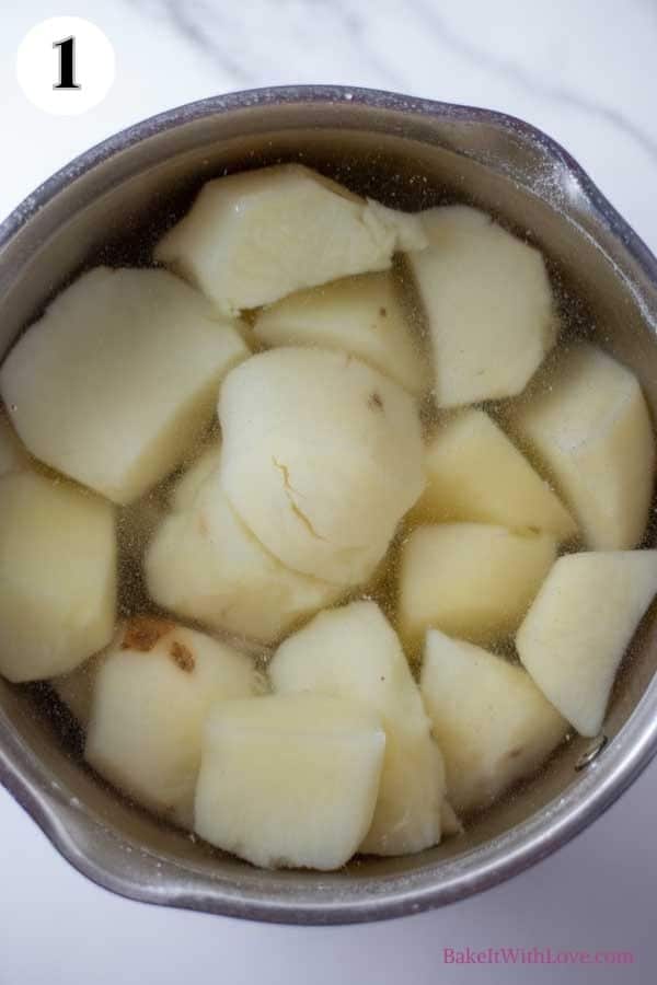 Colcannon process photo 1 showing potatoes in a pot of water.