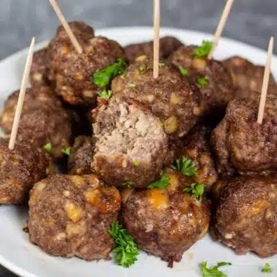 Tall image showing air fryer meatballs on a white plate.
