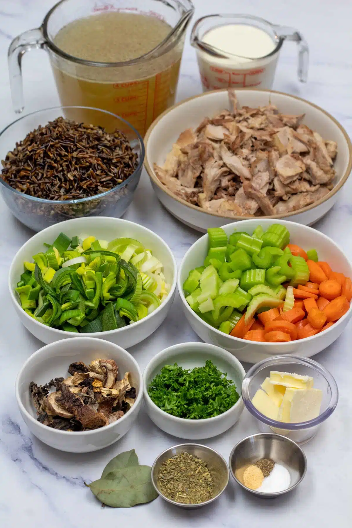 Tall image of ingredients needed for duck and wild rice soup.