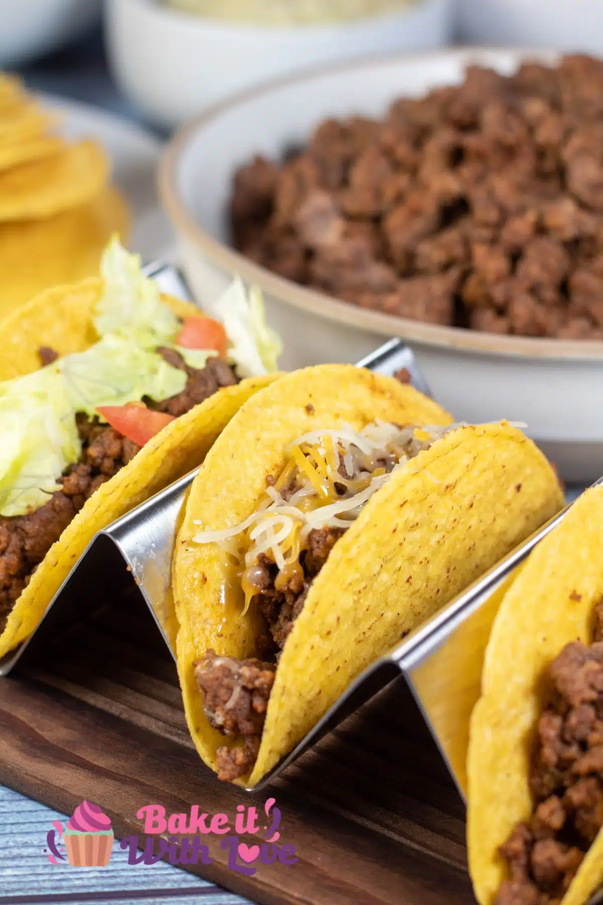Tall image of a trio of ground beef tacos.