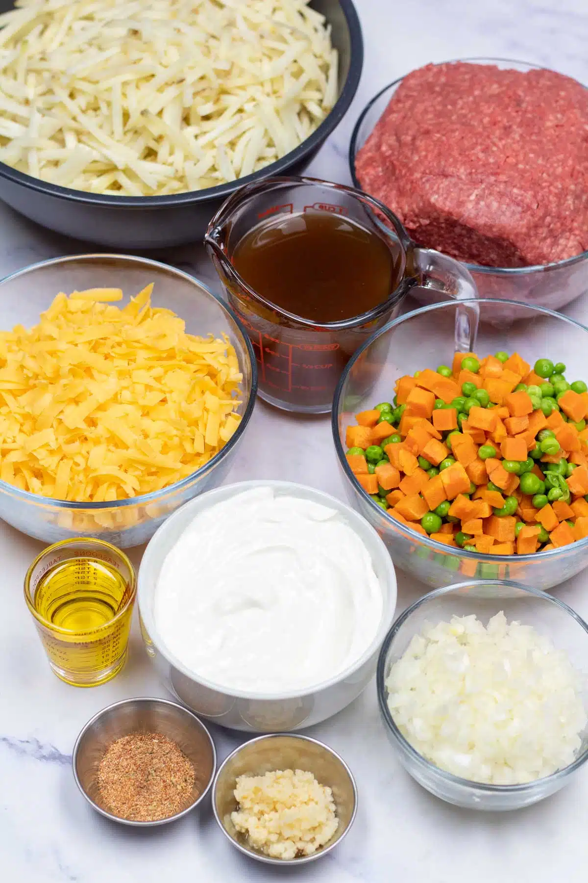 Tall image showing hamburger hashbrown casserole ingredients.