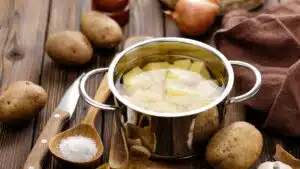 Wide image of potatoes boiling.