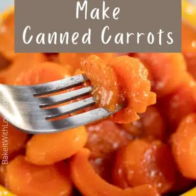 Pin image showing canned cooked carrots in a bowl.