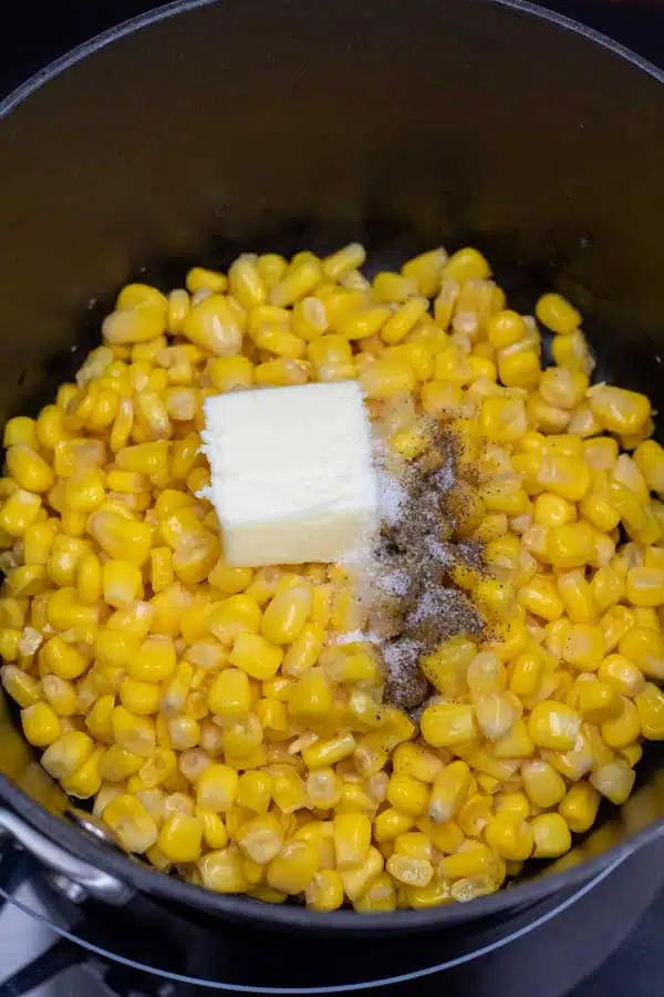 Process image 1 showing corn in a saucepan with seasoning and butter.