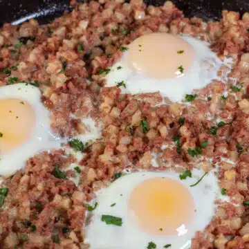 Wide image showing canned corned beef hash and eggs.